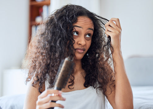 Woman unsatisfied with her dry and frizzy hair