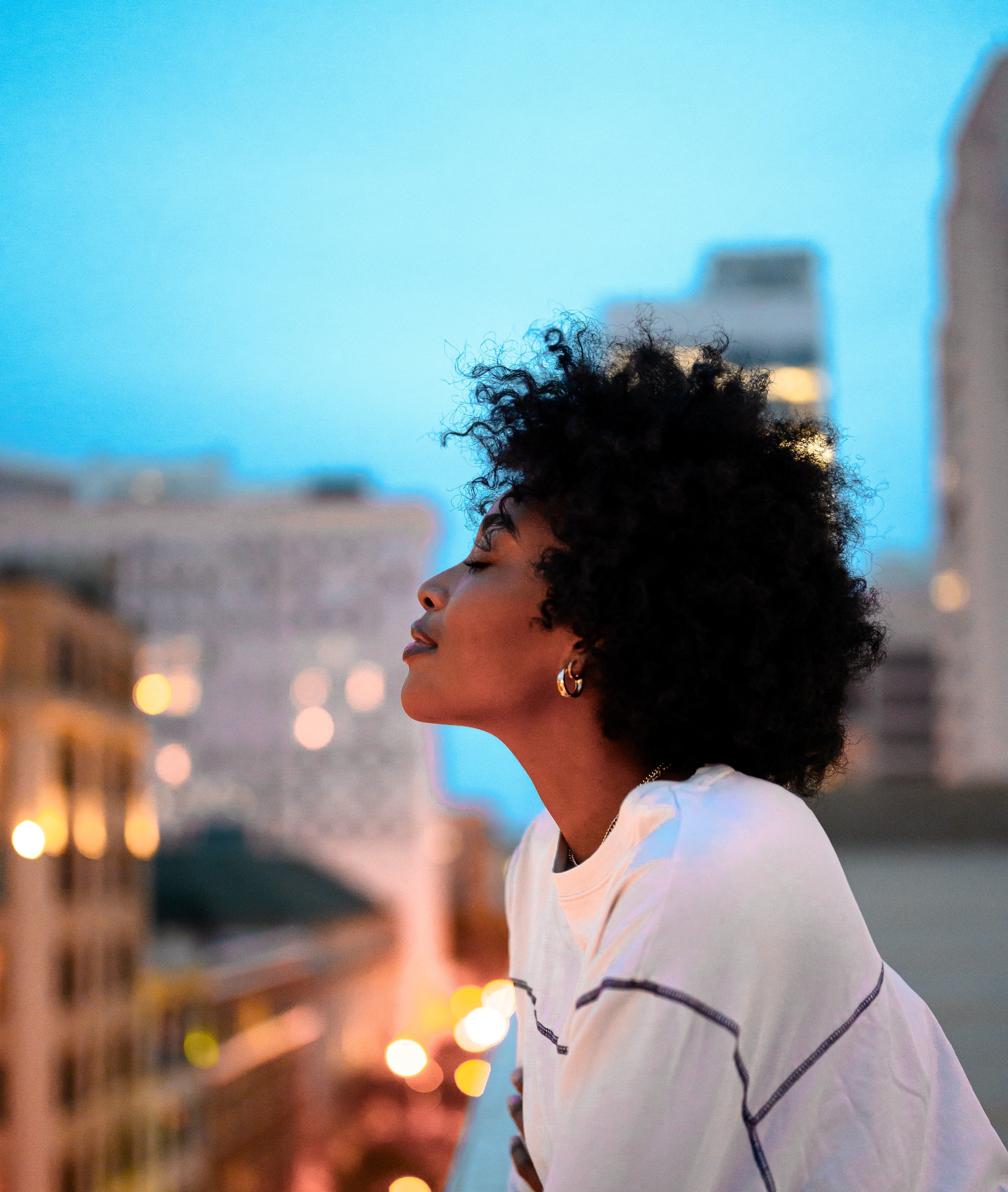 Girl with curly hair after hair growth oil applied to curly hair ends