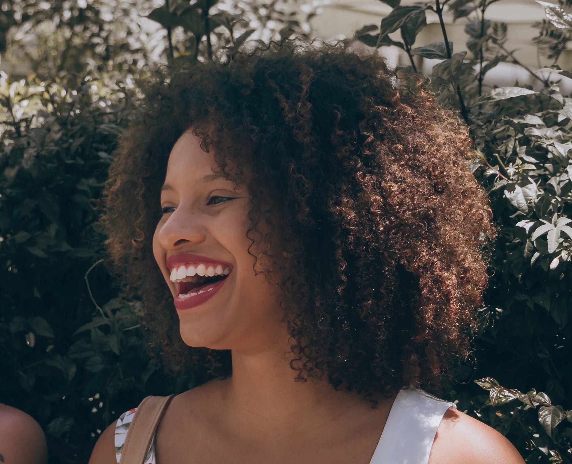 Girl with curly hair laughing