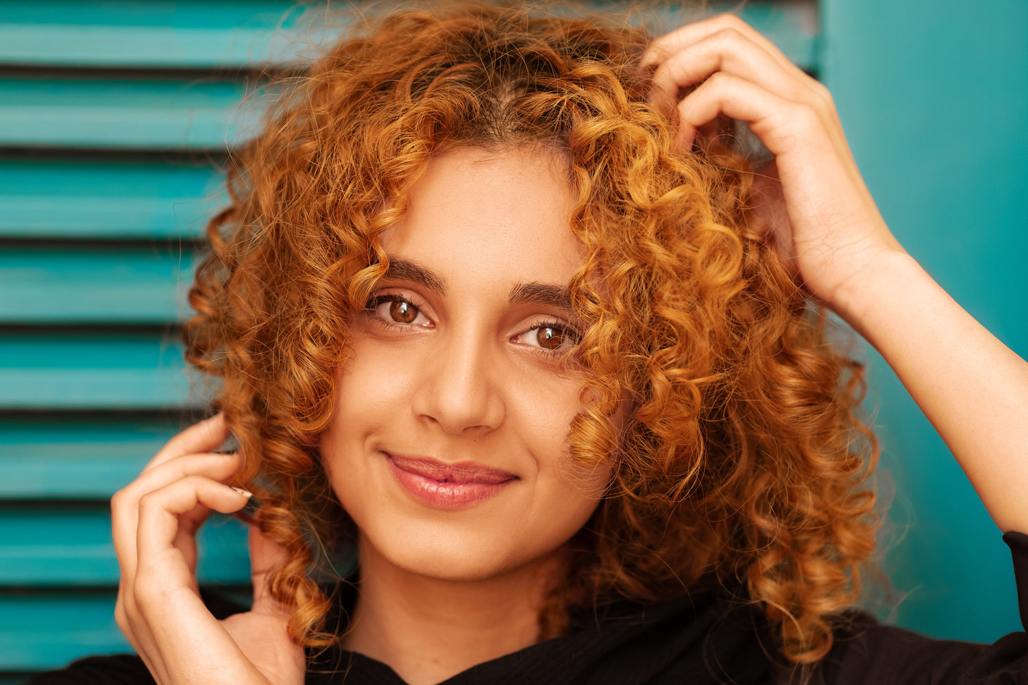 girl with curly hair using shampoo and cleanser